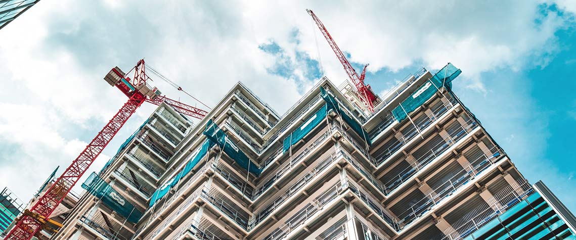 Upward view of tall building under construction.